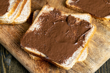 Chocolate butter spread on bread while cooking breakfast
