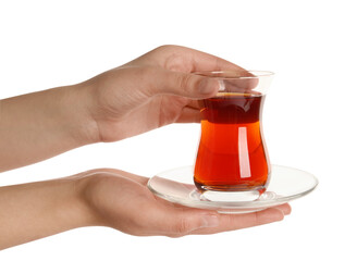 Woman holding glass of traditional Turkish tea with saucer on white background, closeup