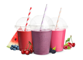 Different delicious smoothies in plastic cups on white background
