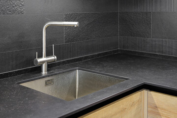 Faucet and steel sink in the kitchen