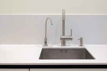 Faucet and steel sink in the kitchen