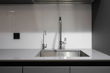 Faucet and steel sink in the kitchen