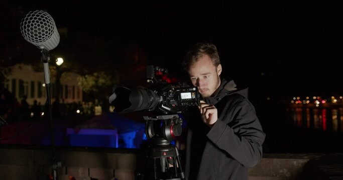 someone is filming a shoot with a cinema camera outside with a river in the background (Behind the Scenes)