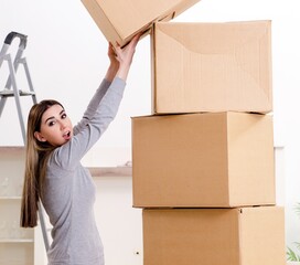 Young beautiful woman moving to new flat