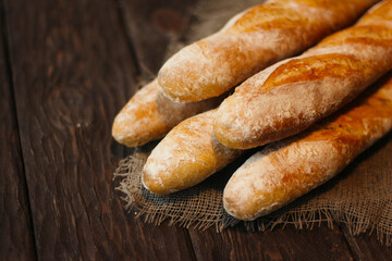 fresh baguettes on a wooden background, pastries