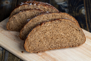 Sliced black rye bread on a board