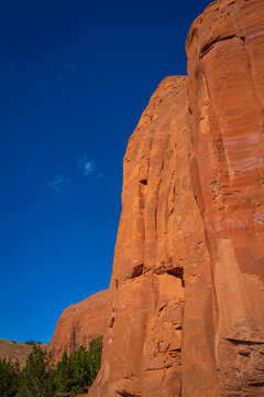 The tall towers of red rock formation and eroded rock walls along the Church Rock Trails in Red Rock Park in Gallup, McKinley County, New Mexico, USA