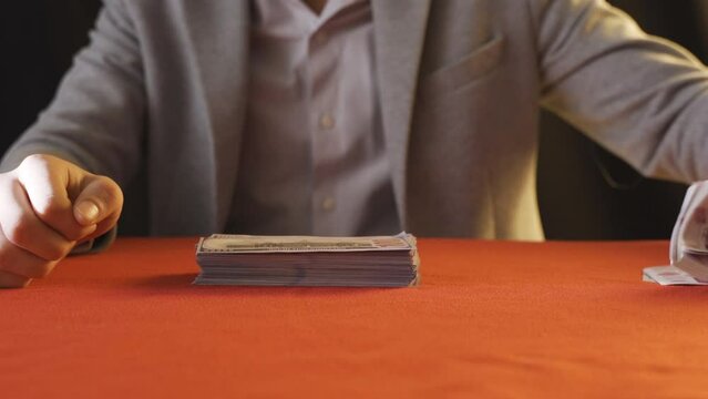 Counting money splitting money.
Rich man counting dollar bills and looking. Financial and investments.
