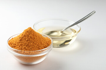 Rice podi a southern Indian powder, a a combination of lentils served in a bowl with oil placed on a white background