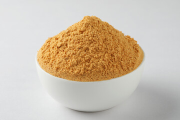 Rice podi a southern Indian powder, a combination of lentils served in a white bowl placed on a white background