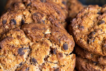 Delicious cookies with pieces of chocolate on the table