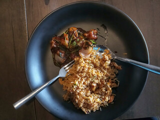Delicous fried rice and chilli chicken, food being served on bamboo sticks at Park Street restaurant, Kolkata, West Bengal, India.