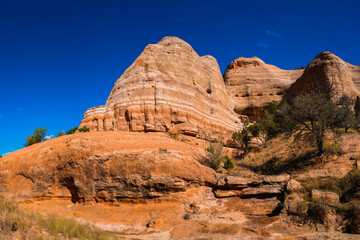 Fototapeta premium Red rock mountain and hills with eroded rock walls along the Church Rock Trails in Red Rock Park in Gallup, McKinley County, New Mexico, USA