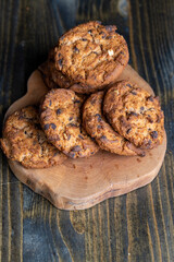 Delicious cookies with pieces of chocolate on the table