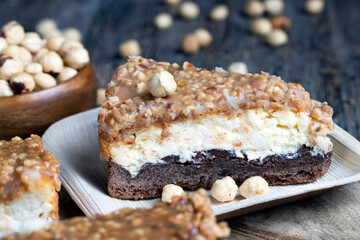 A piece of cheesecake cake with roasted peanuts in caramel