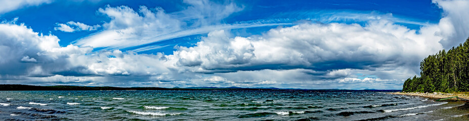 blue sky with white clouds over lake