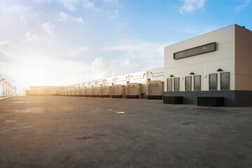 Fototapeta na wymiar Warehouse exterior with shutter doors and truck parking lots