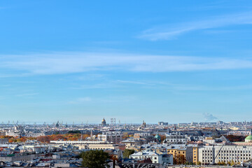 Fototapeta premium Rooftops of a European city on an autumn day. Cityscape taken from the observation deck. Roofs of houses and buildings, domes of churches and cathedrals taken from a great height.