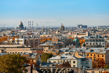 Naklejka premium View of the roofs of the old big city from a height. European city on an autumn sunny day.