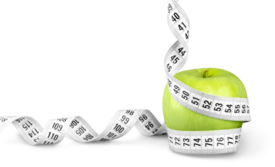 Body Measuring Tape Around A Green Apple