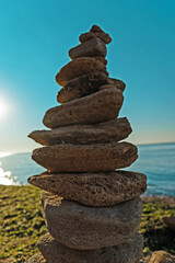 Fototapeta na wymiar Laying beach stones balancing rocks on a sand seashore