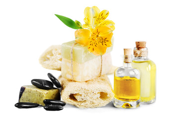 Healthy spa concept with handmade soap bars, oil bottles, sponge and flowers