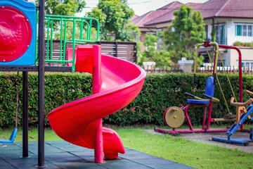 Blank red slide in garden outdoor playground background no children