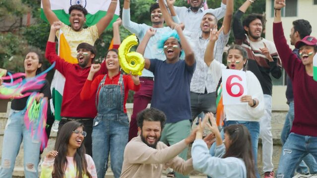 excited audience celebrating sixer by shouting and screaming by showing hand gestures and signs while watching cricket match at stadium - concept of entertainment, enjoyment and joyful spectators