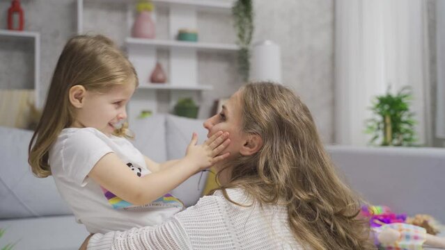 Mother and her cute little daughter.
Mother and daughter talk among themselves, have fun and laugh.
