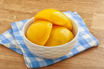 Sweet canned peaches with syrope