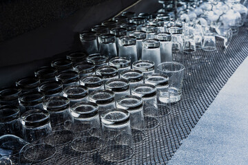 Clean and empty upside down beverage glasses arrangement in restaurant
