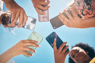 Phone circle, hands of people and low angle, communication or text. Blue sky, mobile and friends on...