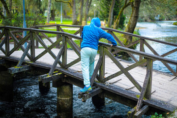 Boy crossing the wood bridge in an unusual way