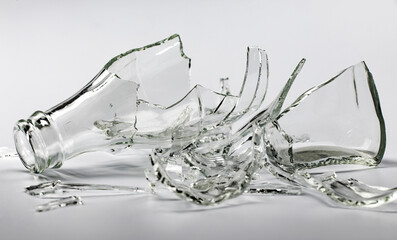 Broken glass bottle. Sharp shards of clear glass.