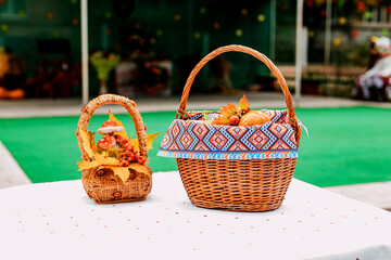 Autumn composition baskets with autumn leaves and berries stand on a white table