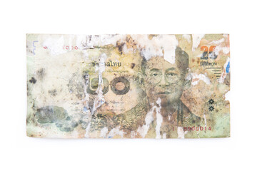 Torn, damaged, decayed Thai banknotes on white background isolated with objects.