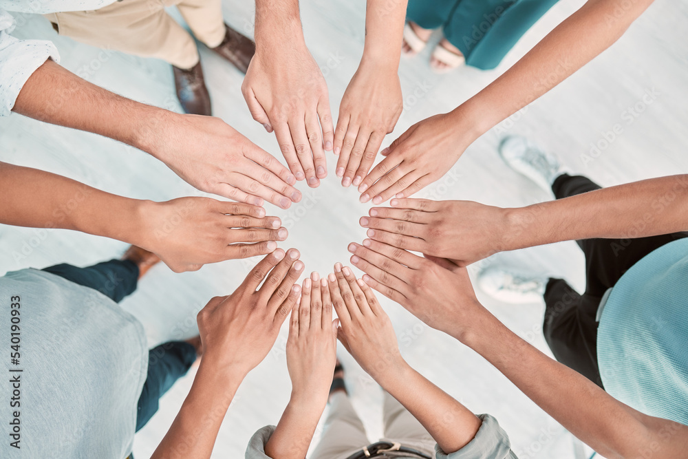 Poster hands, collaboration and motivation with a business team standing in a huddle or circle from above. 