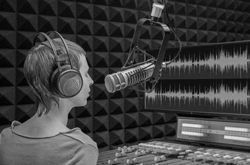 girl announcer in the studio speaks into the microphone