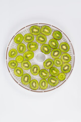 close-up, fresh kiwi sliced ​​on a round grill, for further drying
