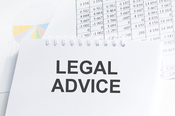 Legal Advice inscription on a notebook on a table on the background of documents