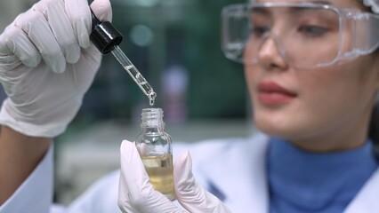 Scientist test CBD hemp oil product in curative CBD lab . The hemp oil contain natural cbd...