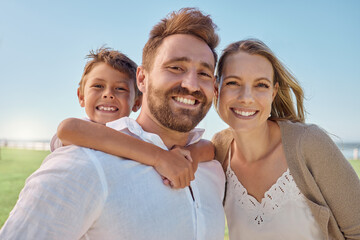 Fototapeta premium Family, children and piggyback with a man, woman and son outdoor on a field during a vacation or holiday together. Kids, travel and love with a mother and father bonding with their boy child outside