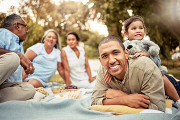 Happy, father and child on a picnic at a park with family for food, adventure and love on a holiday in Germany together. Portrait of a dad with smile for lunch in nature with a girl, parents and mom