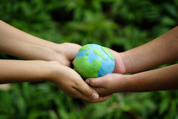 Green Energy, ESG, Renewable and Sustainable Resources. Environmental Care. Hands of People Embracing a Handmade Globe. Protecting Planet Together. World Earth Day Concept.