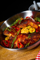 Fried chicken legs with various vegetables and spices