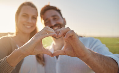 Heart, hands and couple with smile in a park for love, care and adventure in their marriage together in France. Happy, young and man and woman on date in nature with a loving gesture with hands