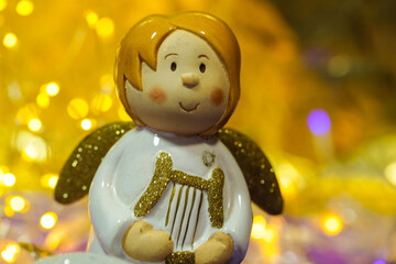 cute angel with Christmas lights as a postcard