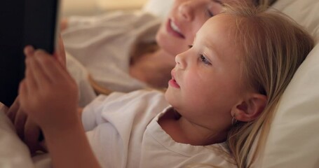 Tablet, mother and child on the internet in bed, streaming a movie or reading a book on the web at night. Education, learning and games on technology for a girl and her mom together in the bedroom - Powered by Adobe