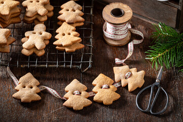 Tasty gingerbread cookies chain as Christmas ornaments.