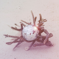 disco ball on sand background with corals. party, disco concept, Christmas and New Year background. relax and vacation style square